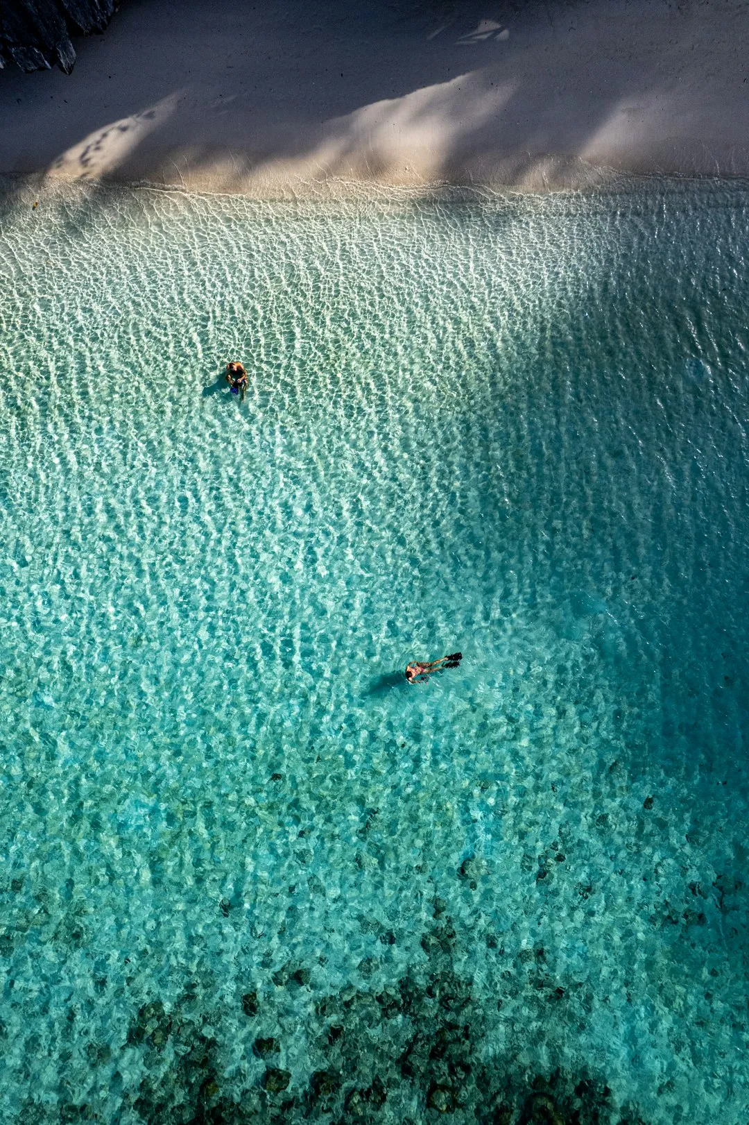 Shallow turquoise water over sandy flats